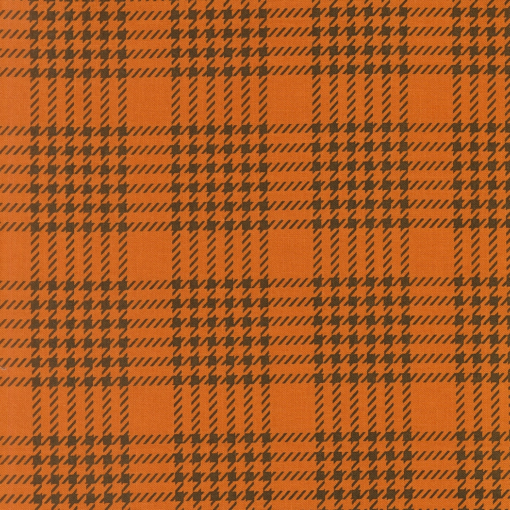 Pumpkin orange houndstooth check cotton quilting fabric. Gothic Haunt by Stacy Iest Hsu. Dark brown shapes, autumn theme.