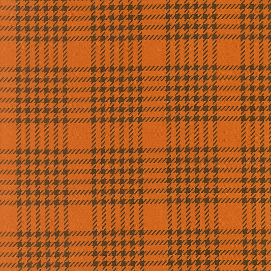 Pumpkin orange houndstooth check cotton quilting fabric. Gothic Haunt by Stacy Iest Hsu. Dark brown shapes, autumn theme.