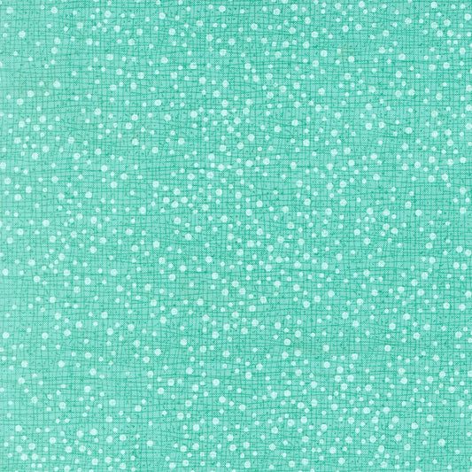 Moda's seafoam green scattered spots cotton quilting fabric. Mums Christmas by Robin Pickens features small white spots.