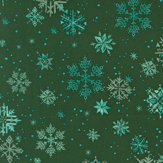 Christmas snowflakes on spruce cotton quilting fabric from Moda's Mums Christmas by Robin Pickens. Stylized snowflakes in blue, aqua, and pale green on deep spruce background.