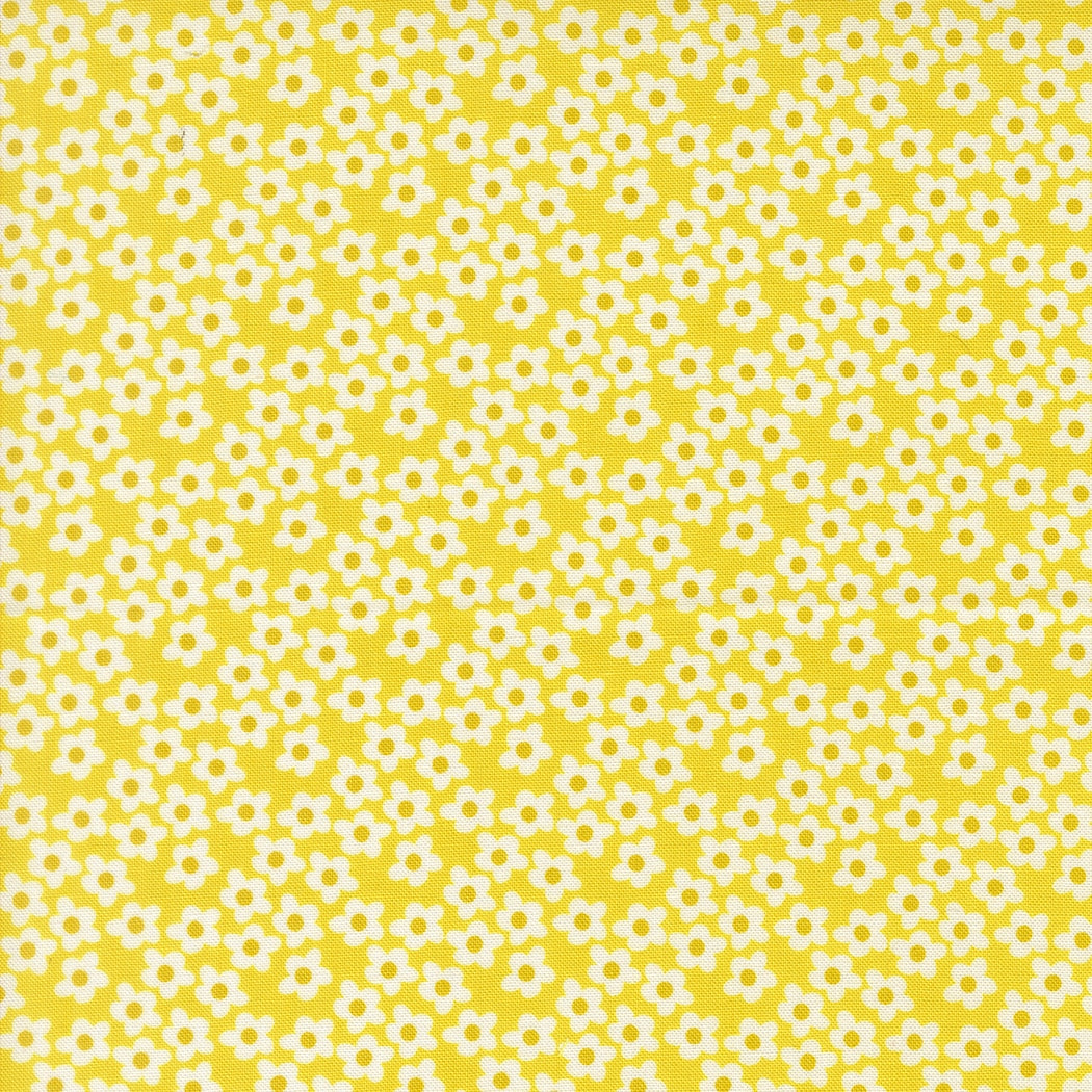 Moda's tiny white flowers with yellow centers on bright yellow Popcorn by Elizabeth Hartman cotton quilting fabric for spring and summer.