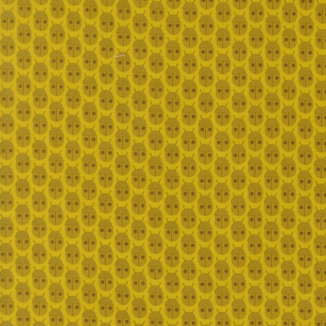 Moda's citrine bug print cotton quilting fabric from Popcorn by Elizabeth Hartman, featuring small olive brown ladybugs on bright citrine yellow.