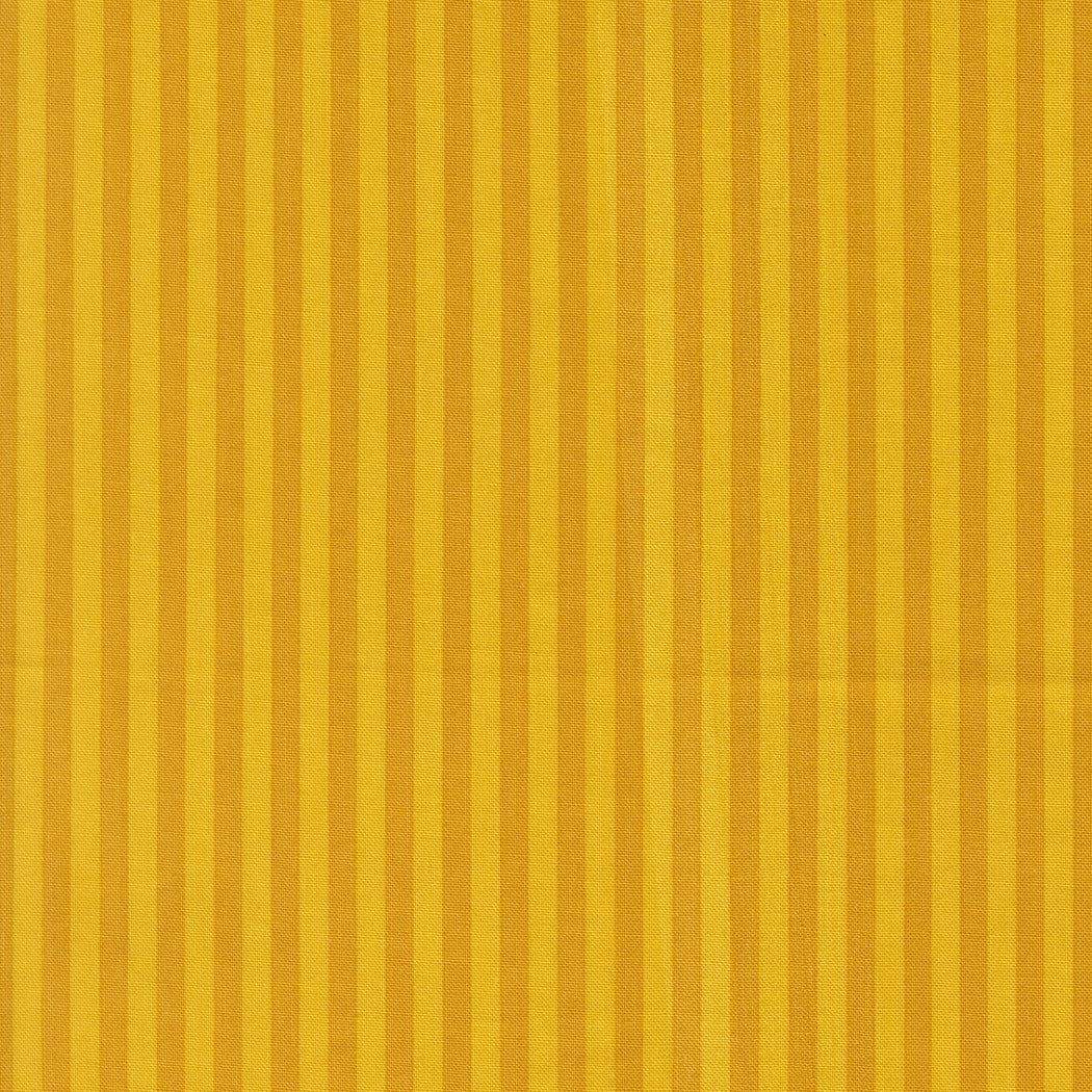 Moda's golden vertical stripes, alternating with deep golden hues, on Popcorn by Elizabeth Hartman cotton quilting fabric.