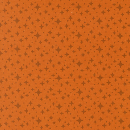 Moda's Popcorn by Elizabeth Hartman cotton quilting fabric. Rust orange ground with small dark brown four-point stars and tiny dots.