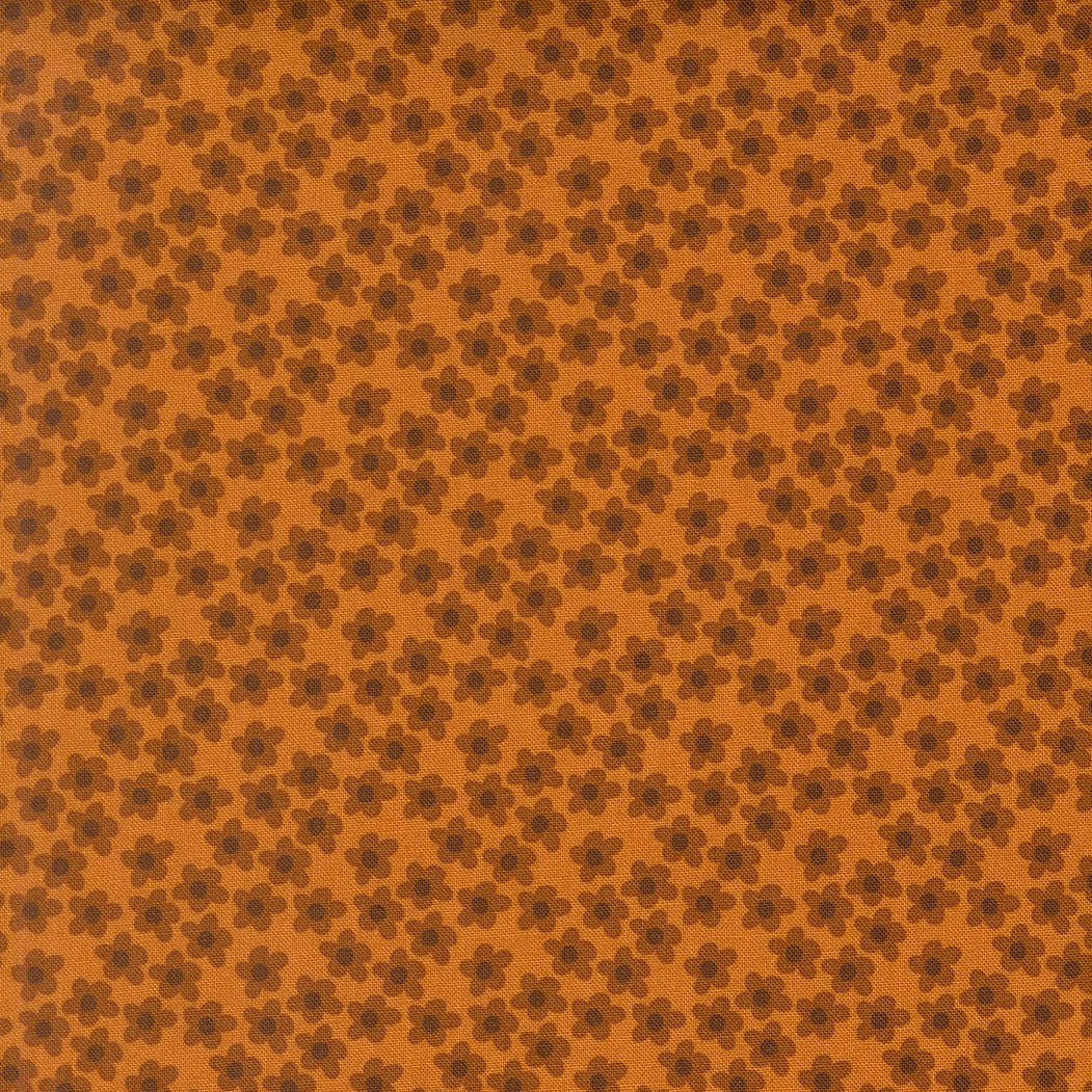 Small amber flowers with dark brown petals scattered on an amber background. Moda's Toast and Jam by Elizabeth Hartman cotton quilting fabric.
