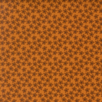 Small amber flowers with dark brown petals scattered on an amber background. Moda's Toast and Jam by Elizabeth Hartman cotton quilting fabric.