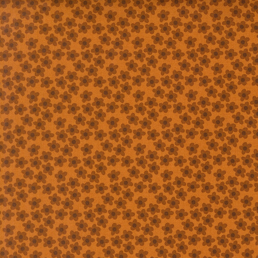Small amber flowers with dark brown petals scattered on an amber background. Moda's Toast and Jam by Elizabeth Hartman cotton quilting fabric.