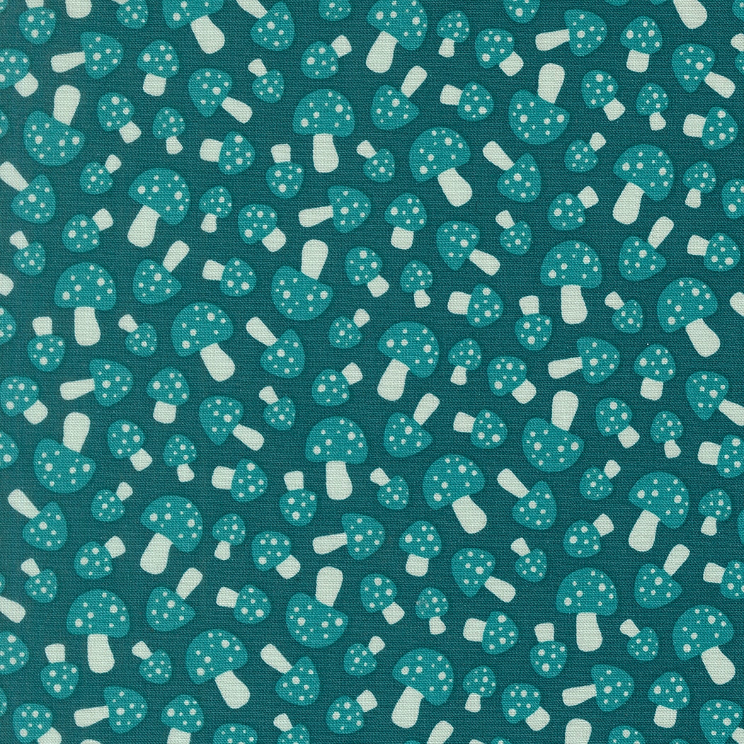 Moda's woodland dark teal polka dot mushrooms cotton quilting fabric from Toast and Jam by Elizabeth Hartman, with lighter teal caps and cream white stems.
