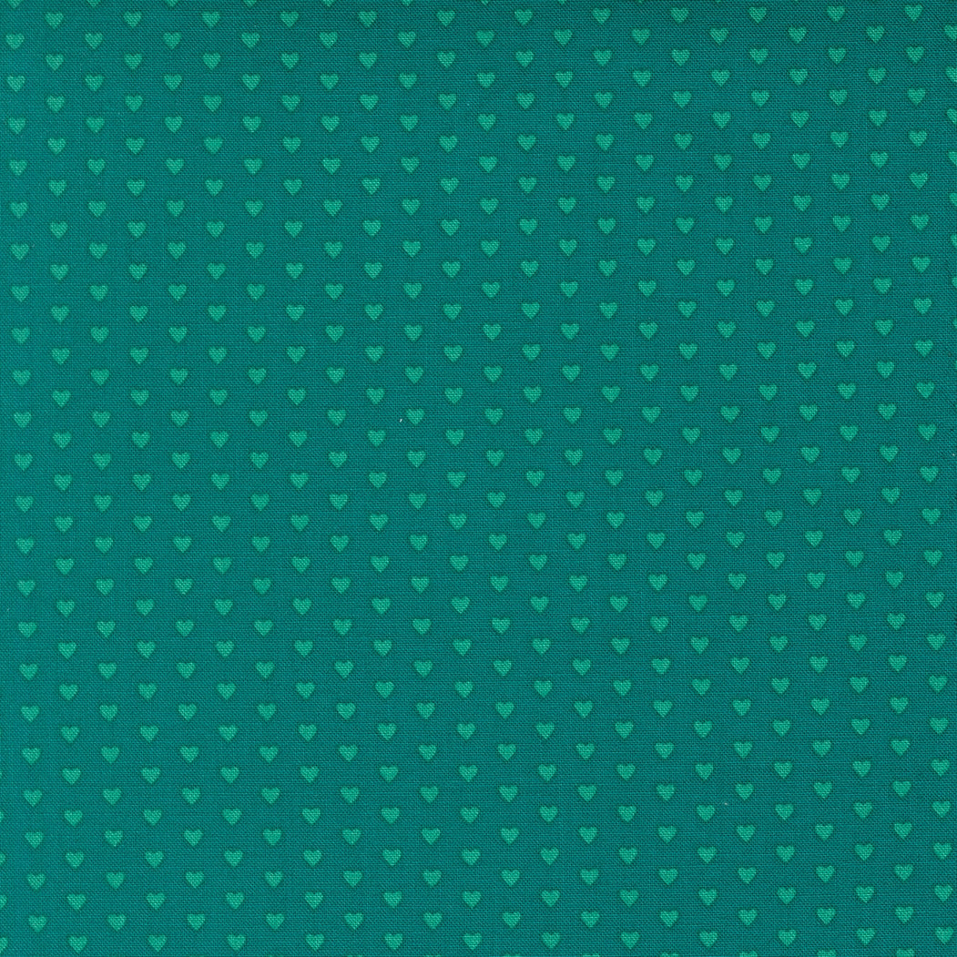 Moda's lagoon small hearts Toast and Jam by Elizabeth Hartman cotton quilting fabric, with small aqua hearts patterned on a deep lagoon background.