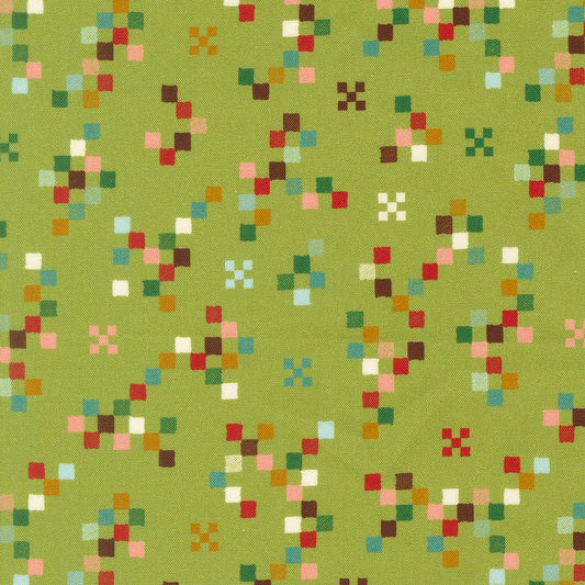 Moda's Twinkle and Tinsel by Fancy That Design House cotton quilting fabric with fern green pixelated squares and scattered multi-colored spots.