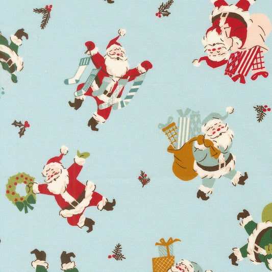 Moda's Twinkle and Tinsel by Fancy That Design House novelty cotton quilting fabric with Christmas Santa figures, gifts, and wreaths on mist blue.