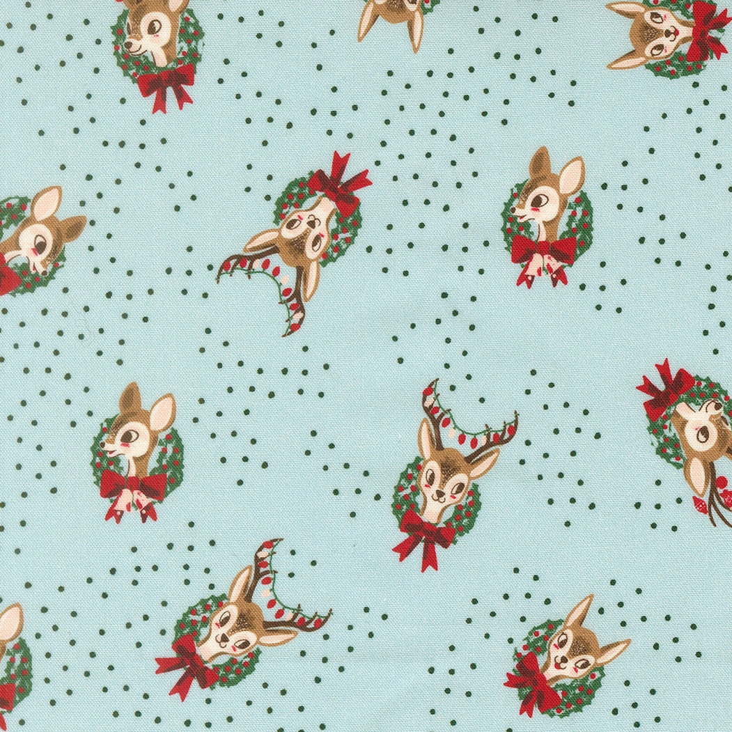 Moda's Twinkle and Tinsel by Fancy That Design House cotton quilting fabric. Christmas deer heads with antlers in green wreaths, red bows & berries on mist blue.