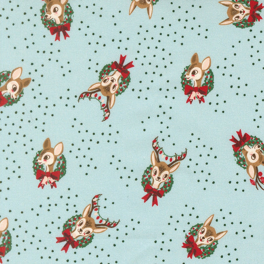 Moda's Twinkle and Tinsel by Fancy That Design House cotton quilting fabric. Christmas deer heads with antlers in green wreaths, red bows & berries on mist blue.