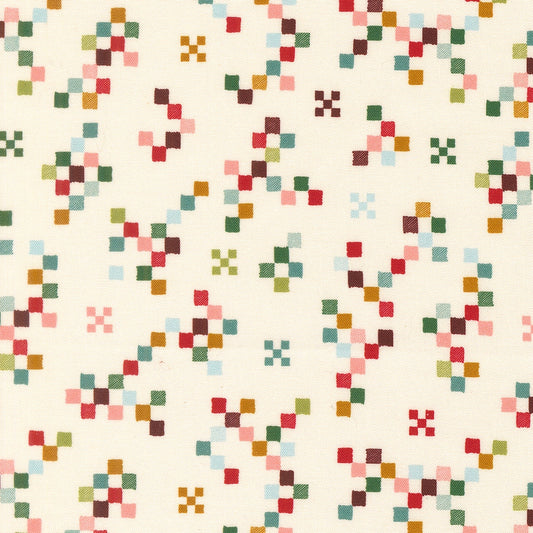 Moda's Twinkle and Tinsel by Fancy That Design House cotton quilting fabric, featuring colorful pixelated geometric shapes and crosses on snow.
