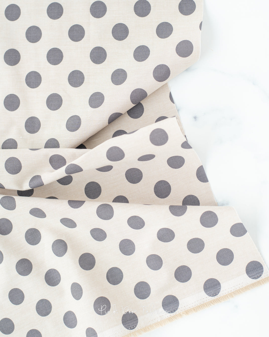 Chambray quilting fabric pattern called 'Charcoal'. Part of the 'Chambray Dots' fabric collection. Designed by Tilda Fabrics for the Tilda Fabrics fabric company. SKU: 160050. 44-45 inch width.