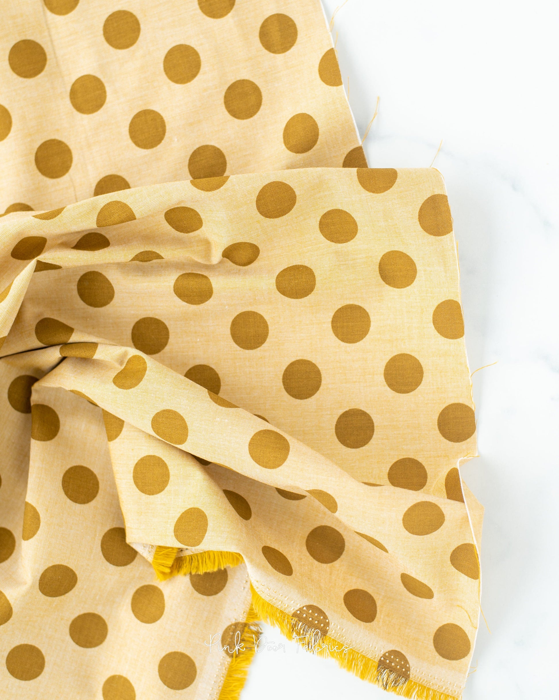 Chambray quilting fabric pattern called 'Dijon'. Part of the 'Chambray Dots' fabric collection. Designed by Tilda Fabrics for the Tilda Fabrics fabric company. SKU: 160051. 44-45 inch width.