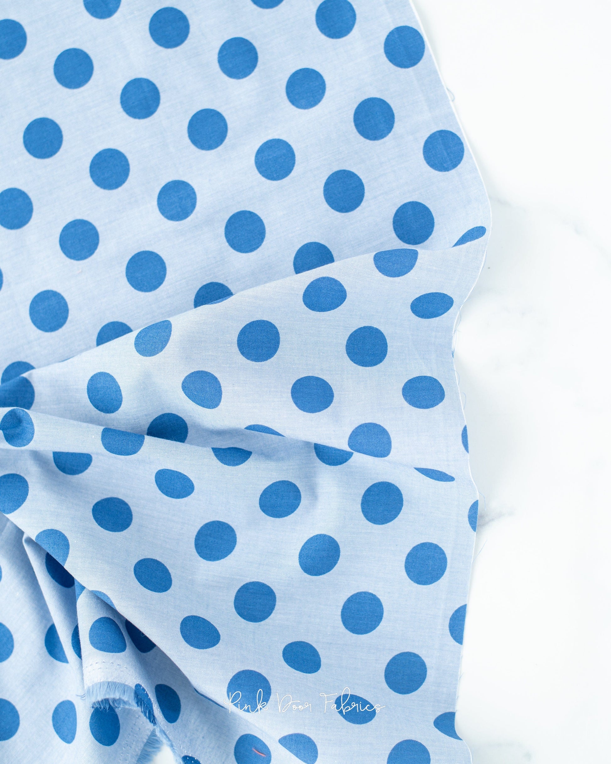 Chambray quilting fabric pattern called 'Cornflower'. Part of the 'Chambray Dots' fabric collection. Designed by Tilda Fabrics for the Tilda Fabrics fabric company. SKU: 160056. 44-45 inch width.