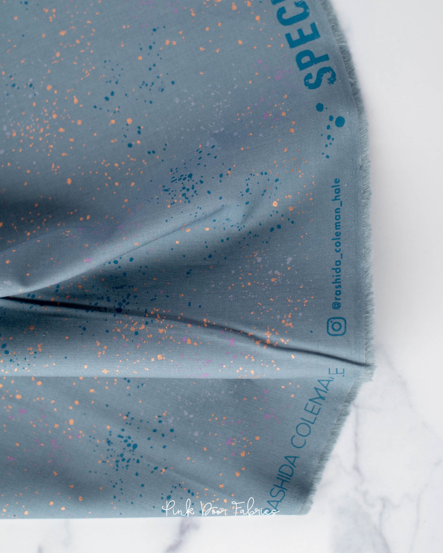 Cotton quilting fabric pattern called 'Blue Slate'. Part of the 'Speckled Metallic' fabric collection. Designed by Ruby Star Society for fabric company Moda Fabrics. SKU: RS5027 108M. 44-45 inch width.