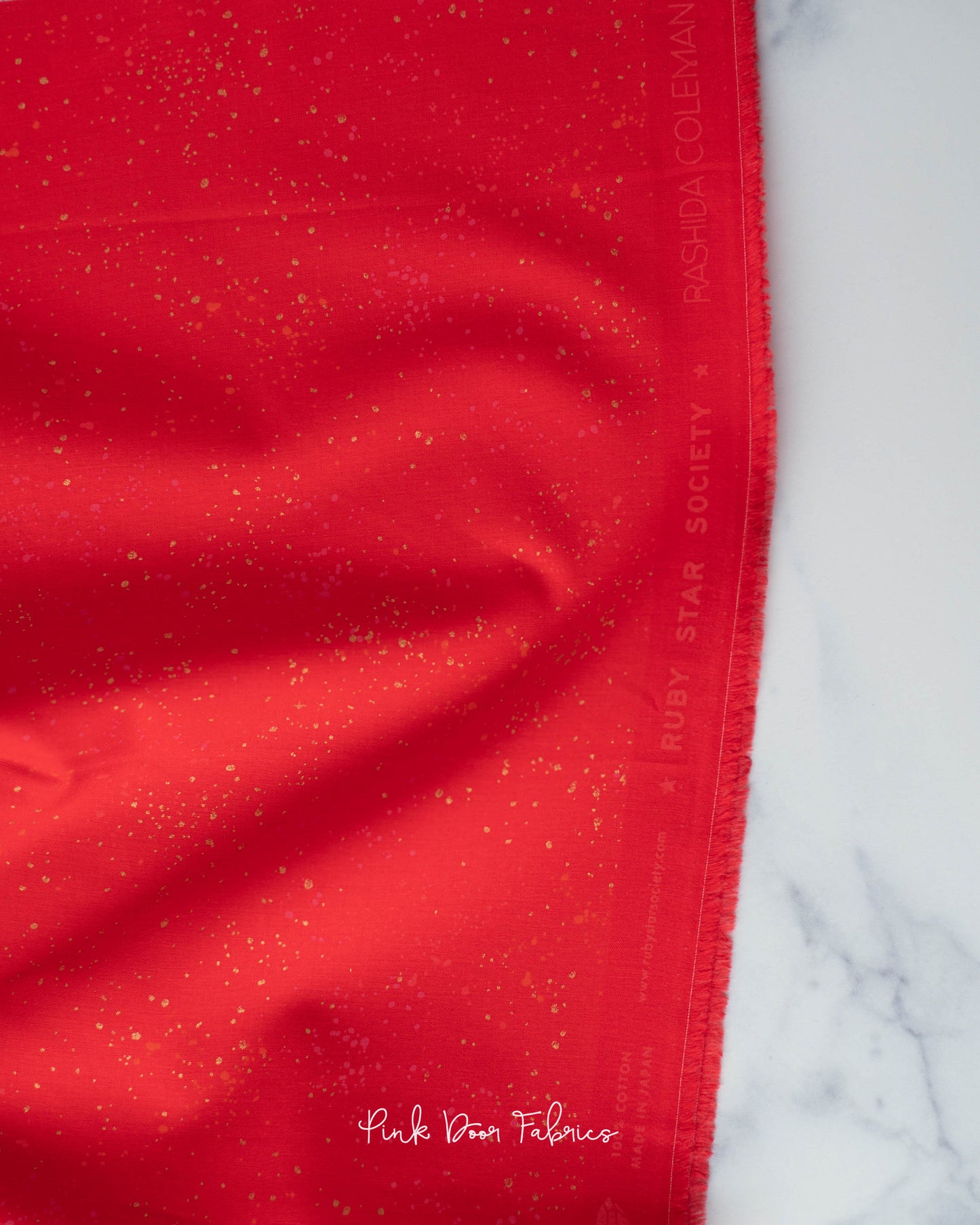 Cotton quilting fabric pattern called 'Scarlet'. Part of the 'Speckled Metallic' fabric collection. Designed by Ruby Star Society for fabric company Moda Fabrics. SKU: RS5027 110M. 44-45 inch width.