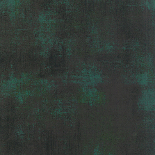 Cotton quilting fabric pattern called 'Grunge in Christmas Green'. Part of the 'Grunge Basics' fabric collection. Designed by Basic Grey for fabric company Moda Fabrics. SKU: 30150-308. 44-45 inch width.