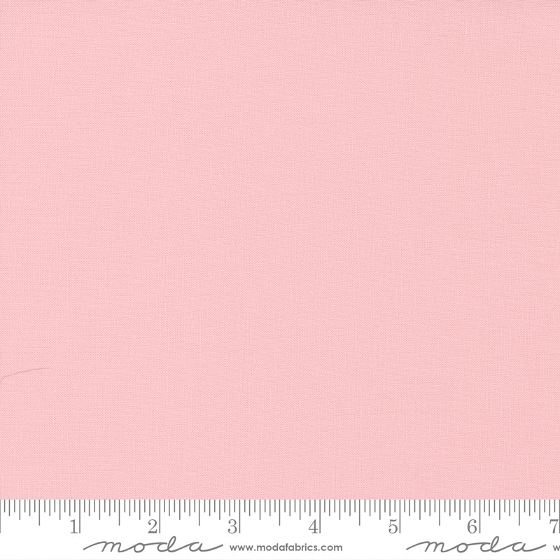 Cotton quilting fabric pattern called 'Sister's Pink'. Part of the 'Bella Solids' fabric collection. Designed by Moda Fabrics for fabric company Moda Fabrics. SKU: 9900 145. 44-45 inch width.