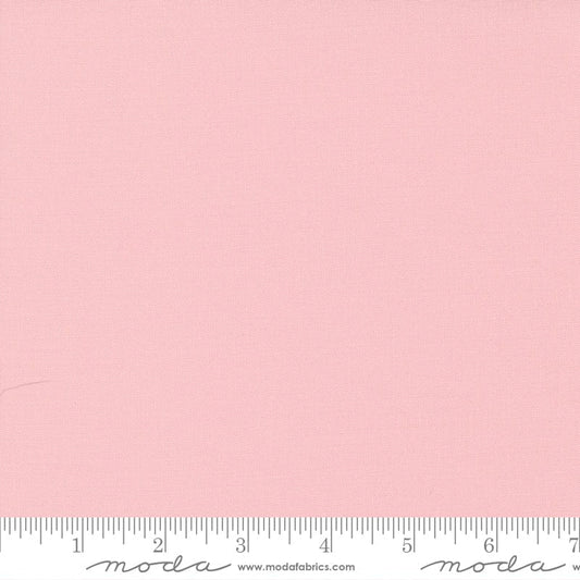 Cotton quilting fabric pattern called 'Sister's Pink'. Part of the 'Bella Solids' fabric collection. Designed by Moda Fabrics for fabric company Moda Fabrics. SKU: 9900 145. 44-45 inch width.