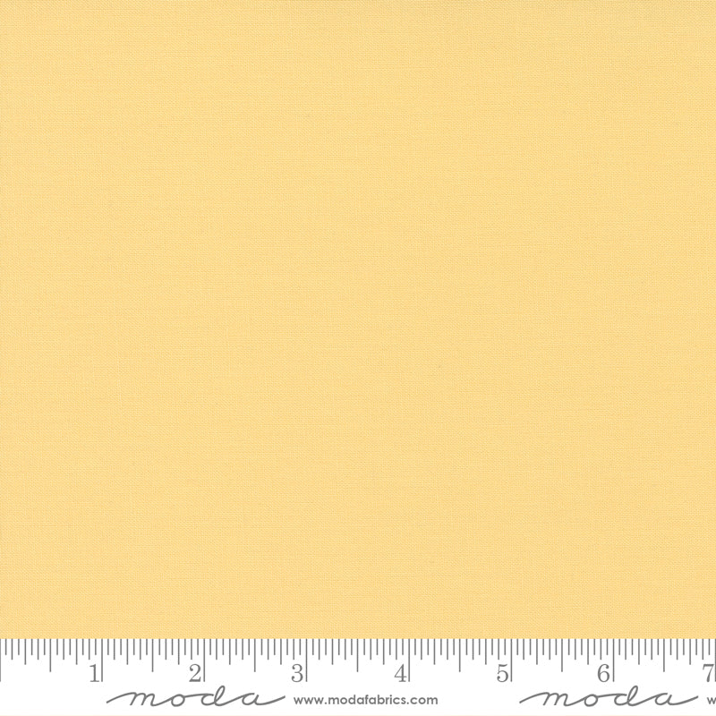 Cotton quilting fabric pattern called 'Soft Yellow'. Part of the 'Bella Solids' fabric collection. Designed by Moda Fabrics for fabric company Moda Fabrics. SKU: 9900 148. 44-45 inch width.