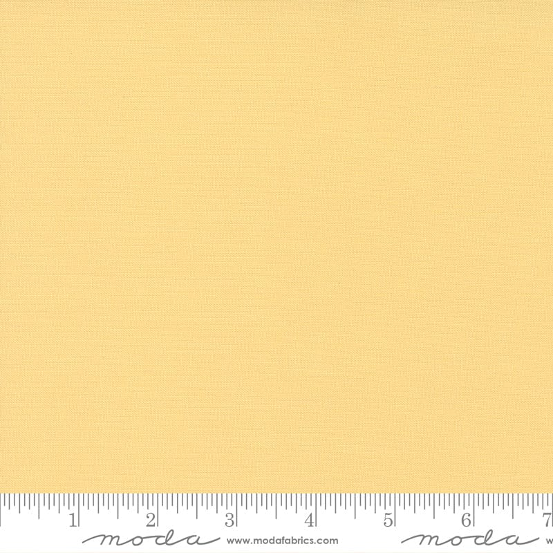 Cotton quilting fabric pattern called 'Soft Yellow'. Part of the 'Bella Solids' fabric collection. Designed by Moda Fabrics for fabric company Moda Fabrics. SKU: 9900 148. 44-45 inch width.