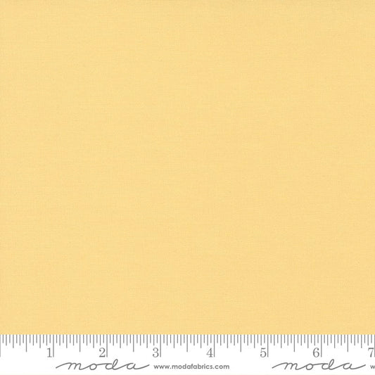 Cotton quilting fabric pattern called 'Soft Yellow'. Part of the 'Bella Solids' fabric collection. Designed by Moda Fabrics for fabric company Moda Fabrics. SKU: 9900 148. 44-45 inch width.