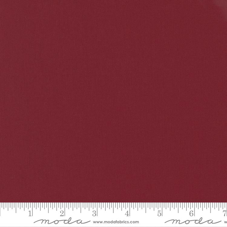 Cotton quilting fabric pattern called 'Kansas Red'. Part of the 'Bella Solids' fabric collection. Designed by Moda Fabrics for fabric company Moda Fabrics. SKU: 9900 150. 44-45 inch width.