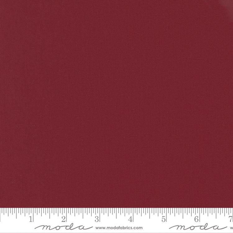 Cotton quilting fabric pattern called 'Kansas Red'. Part of the 'Bella Solids' fabric collection. Designed by Moda Fabrics for fabric company Moda Fabrics. SKU: 9900 150. 44-45 inch width.