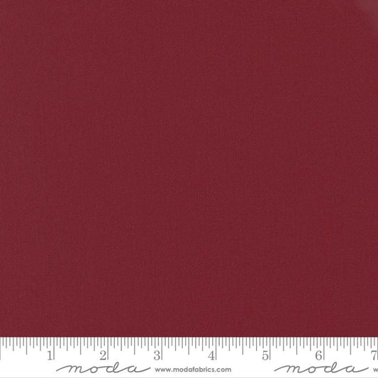 Cotton quilting fabric pattern called 'Kansas Red'. Part of the 'Bella Solids' fabric collection. Designed by Moda Fabrics for fabric company Moda Fabrics. SKU: 9900 150. 44-45 inch width.