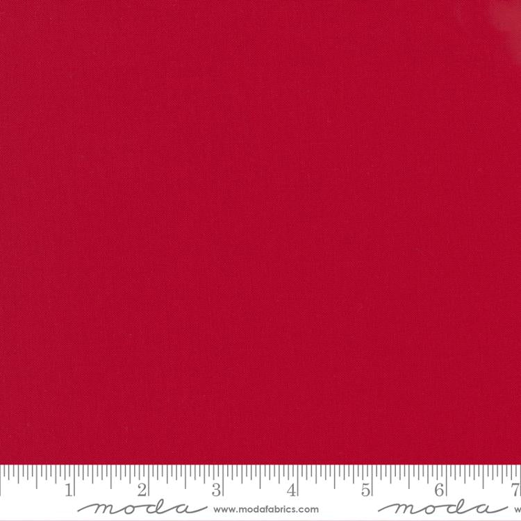 Cotton quilting fabric pattern called 'Christmas Red'. Part of the 'Bella Solids' fabric collection. Designed by Moda Fabrics for fabric company Moda Fabrics. SKU: 9900 16. 44-45 inch width.