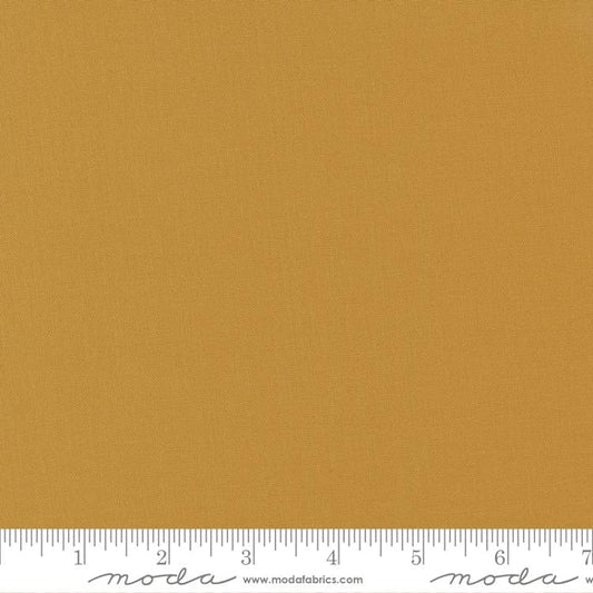 Cotton quilting fabric pattern called 'Harvest Gold'. Part of the 'Bella Solids' fabric collection. Designed by Moda Fabrics for fabric company Moda Fabrics. SKU: 9900 244. 44-45 inch width.