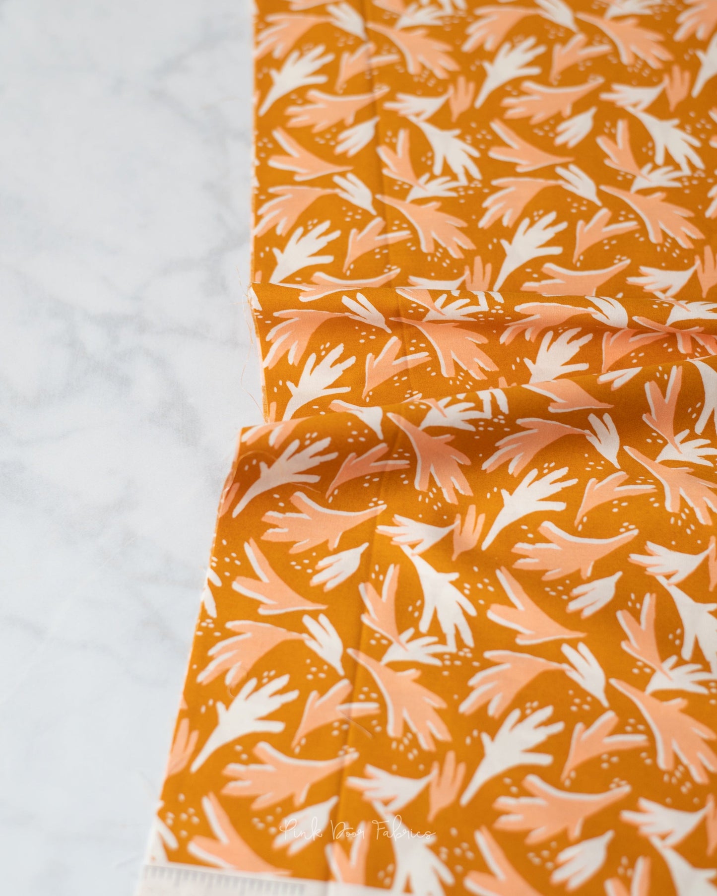 Cotton quilting fabric pattern called 'Freckled Leaves'. Part of the 'Terra Kotta' fabric collection. Designed by AGF Studio for fabric company Art Gallery Fabrics. SKU: CAP-TK-1505. 44-45 inch width.