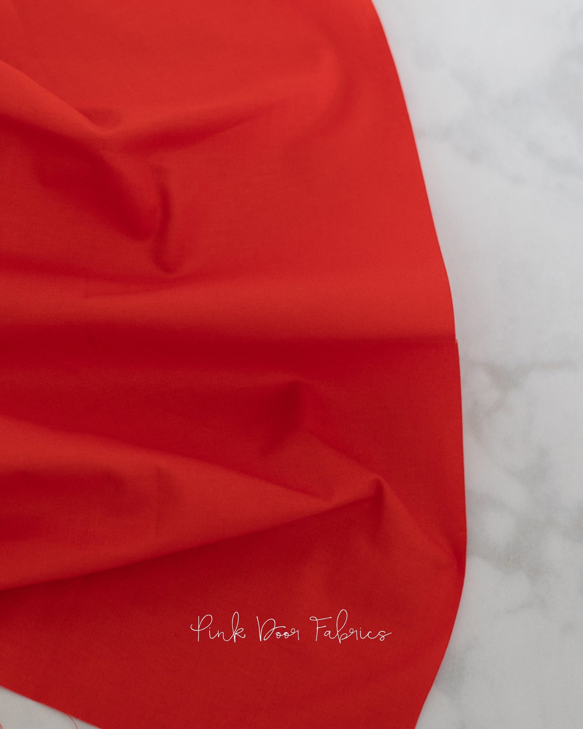 Cotton quilting fabric pattern called 'Dragon's Breath in Carnelian'. Part of the 'True Colors' fabric collection. Designed by Tula Pink for fabric company Free Spirit Fabrics. SKU: CSFSESS.CARNELIAN. 44-45 inch width.