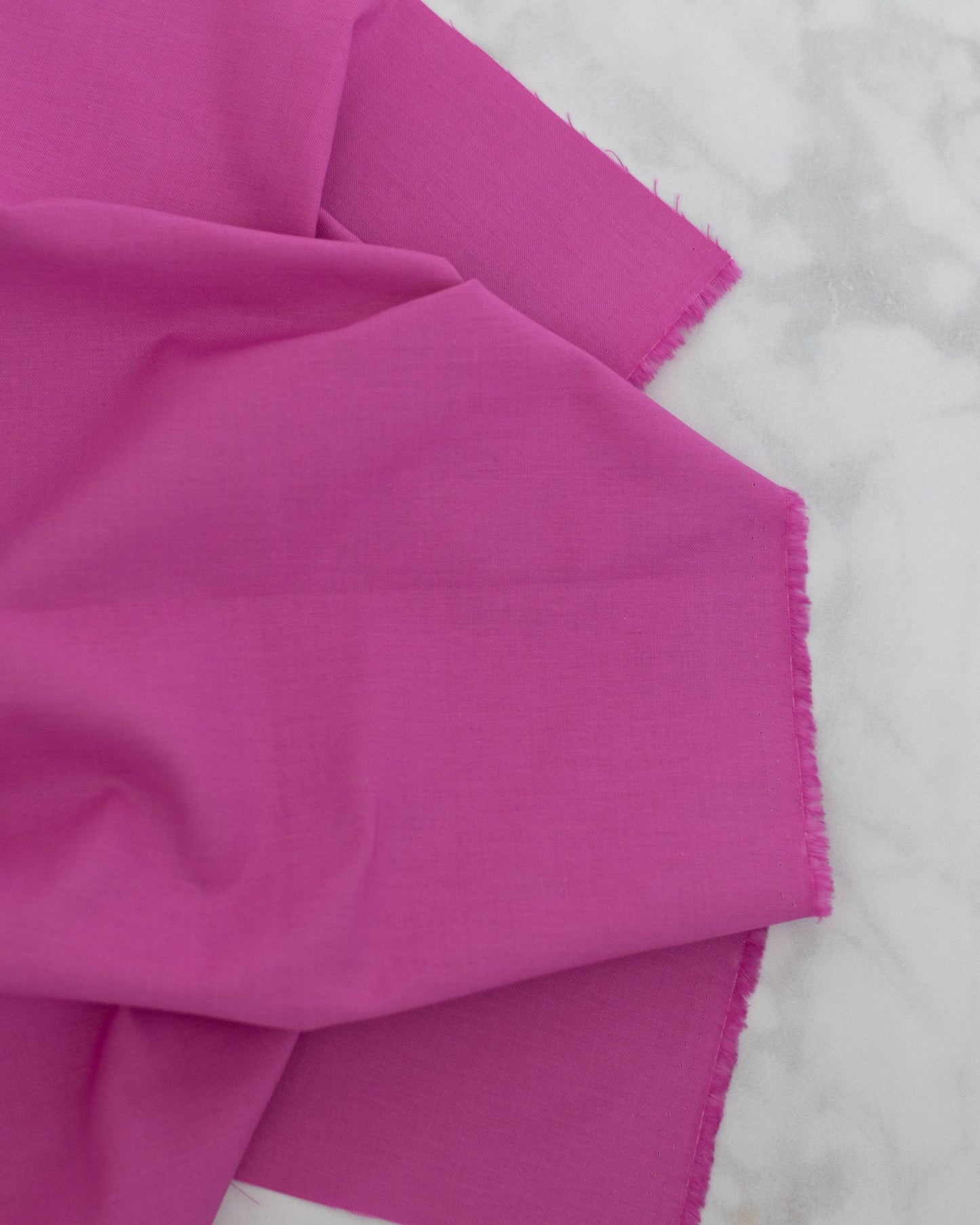 Cotton quilting fabric pattern called 'Solid in Cosmo'. Part of the 'True Colors' fabric collection. Designed by Tula Pink for fabric company Free Spirit Fabrics. SKU: CSFSESS.COSMO. 44-45 inch width.