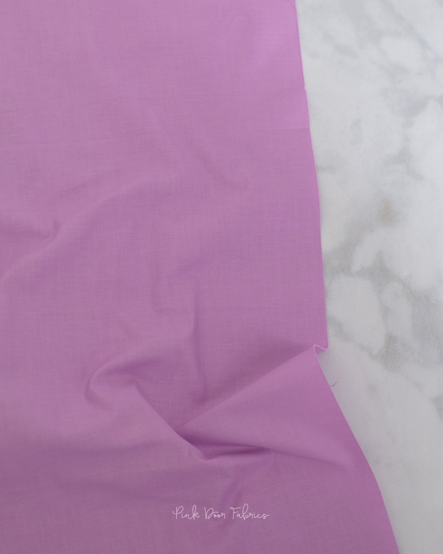 Cotton quilting fabric pattern called 'Solid in Freesia'. Part of the 'True Colors' fabric collection. Designed by Tula Pink for fabric company Free Spirit Fabrics. SKU: CSFSESS.FREESIA. 44-45 inch width.