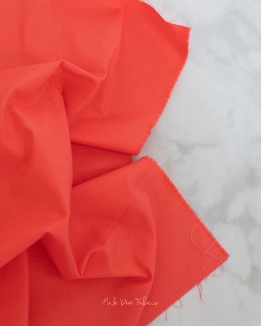 Cotton quilting fabric pattern called 'Solid in Hibiscus'. Part of the 'True Colors' fabric collection. Designed by Tula Pink for fabric company Free Spirit Fabrics. SKU: CSFSESS.HIBISCUS. 44-45 inch width.