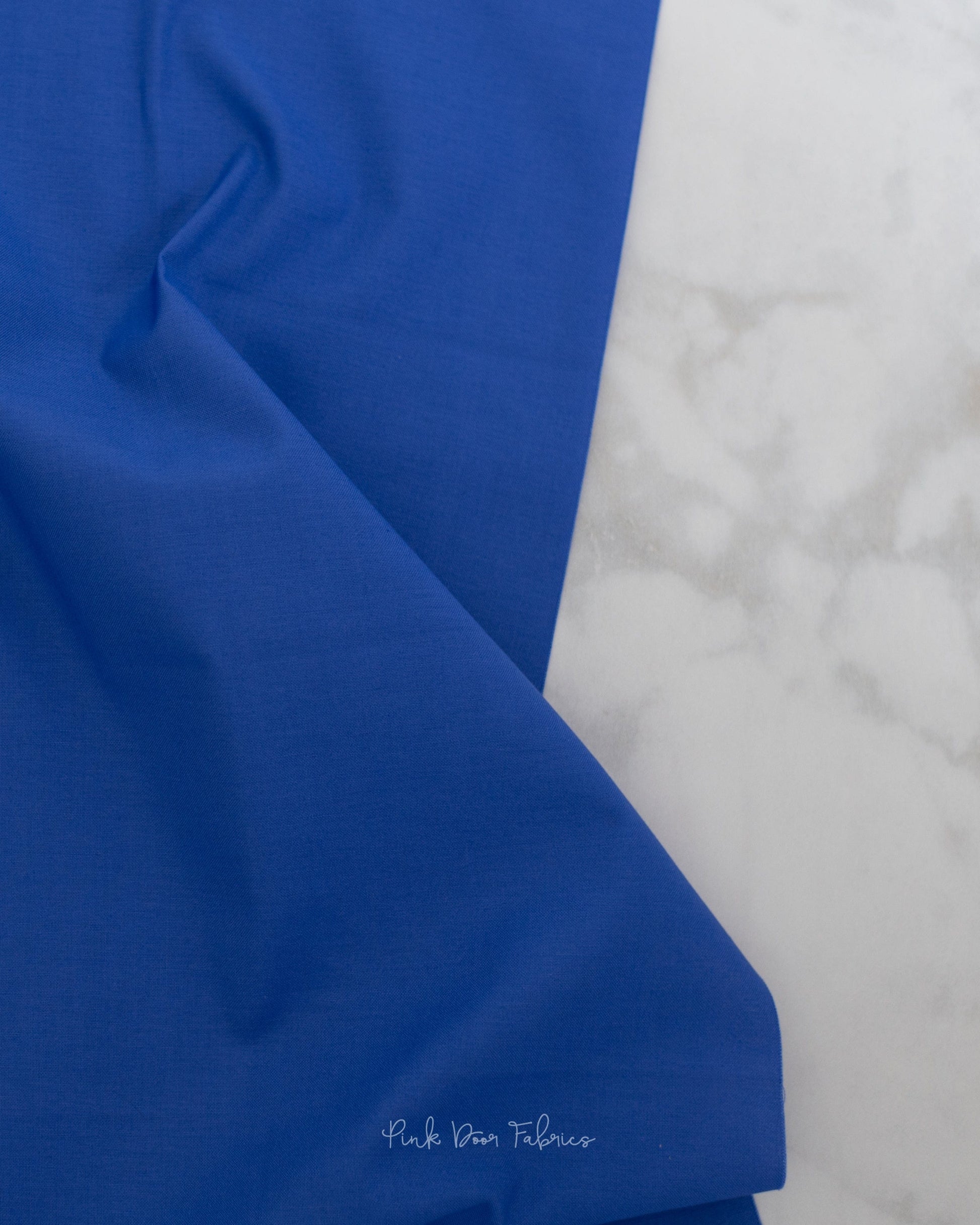 Cotton quilting fabric pattern called 'Solid in Iris'. Part of the 'True Colors' fabric collection. Designed by Tula Pink for fabric company Free Spirit Fabrics. SKU: CSFSESS.IRIS. 44-45 inch width.