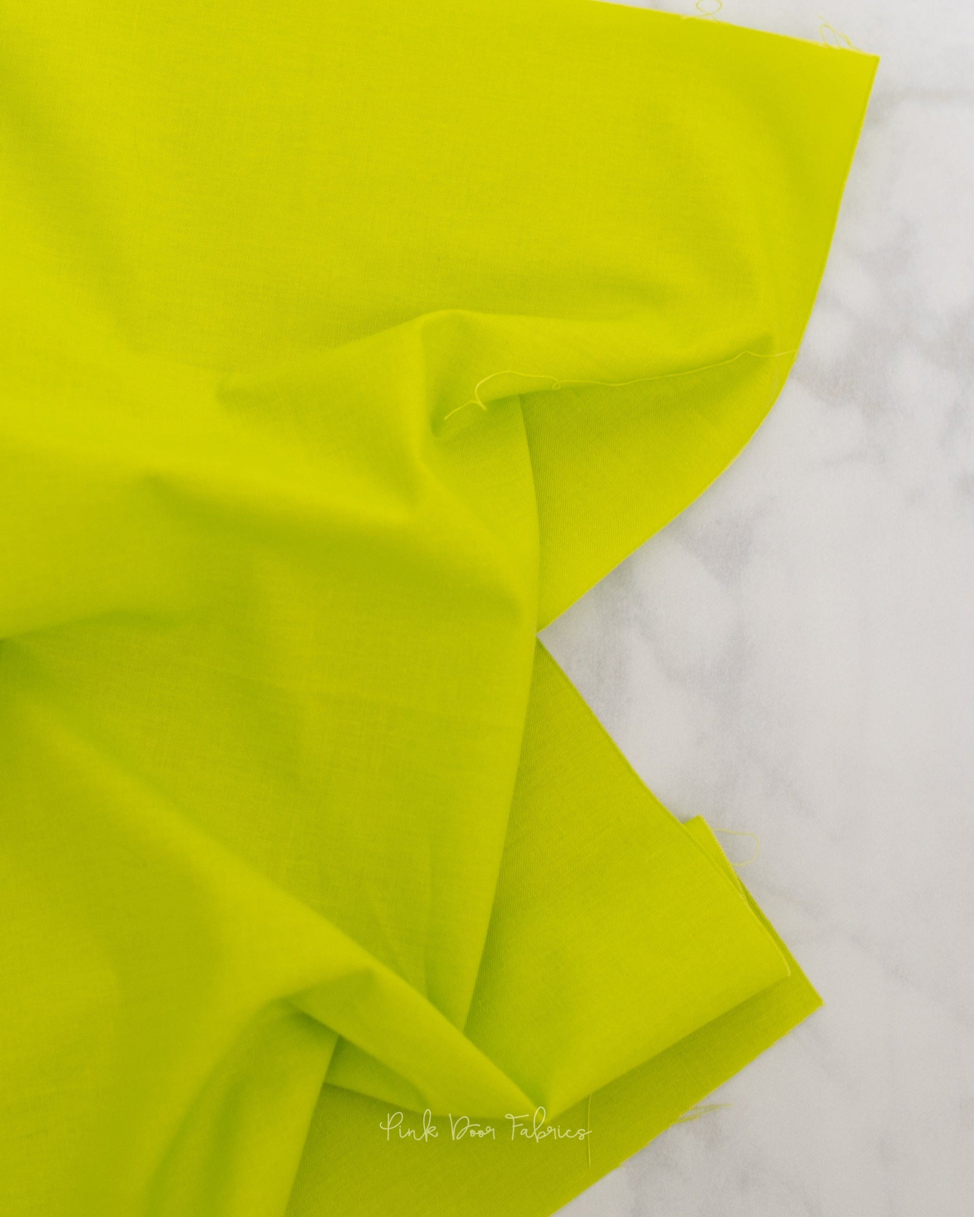 Cotton quilting fabric pattern called 'Solid in Limeade'. Part of the 'True Colors' fabric collection. Designed by Tula Pink for fabric company Free Spirit Fabrics. SKU: CSFSESS.LIMEADE. 44-45 inch width.