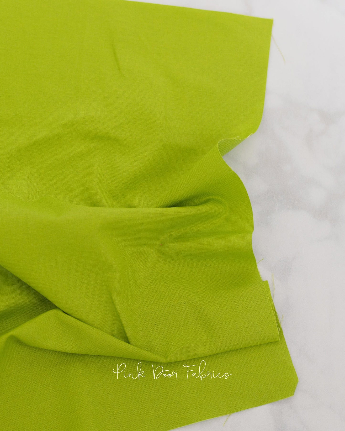 Cotton quilting fabric pattern called 'Dragon's Breath in Matcha'. Part of the 'True Colors' fabric collection. Designed by Tula Pink for fabric company Free Spirit Fabrics. SKU: CSFSESS.MATCH. 44-45 inch width.