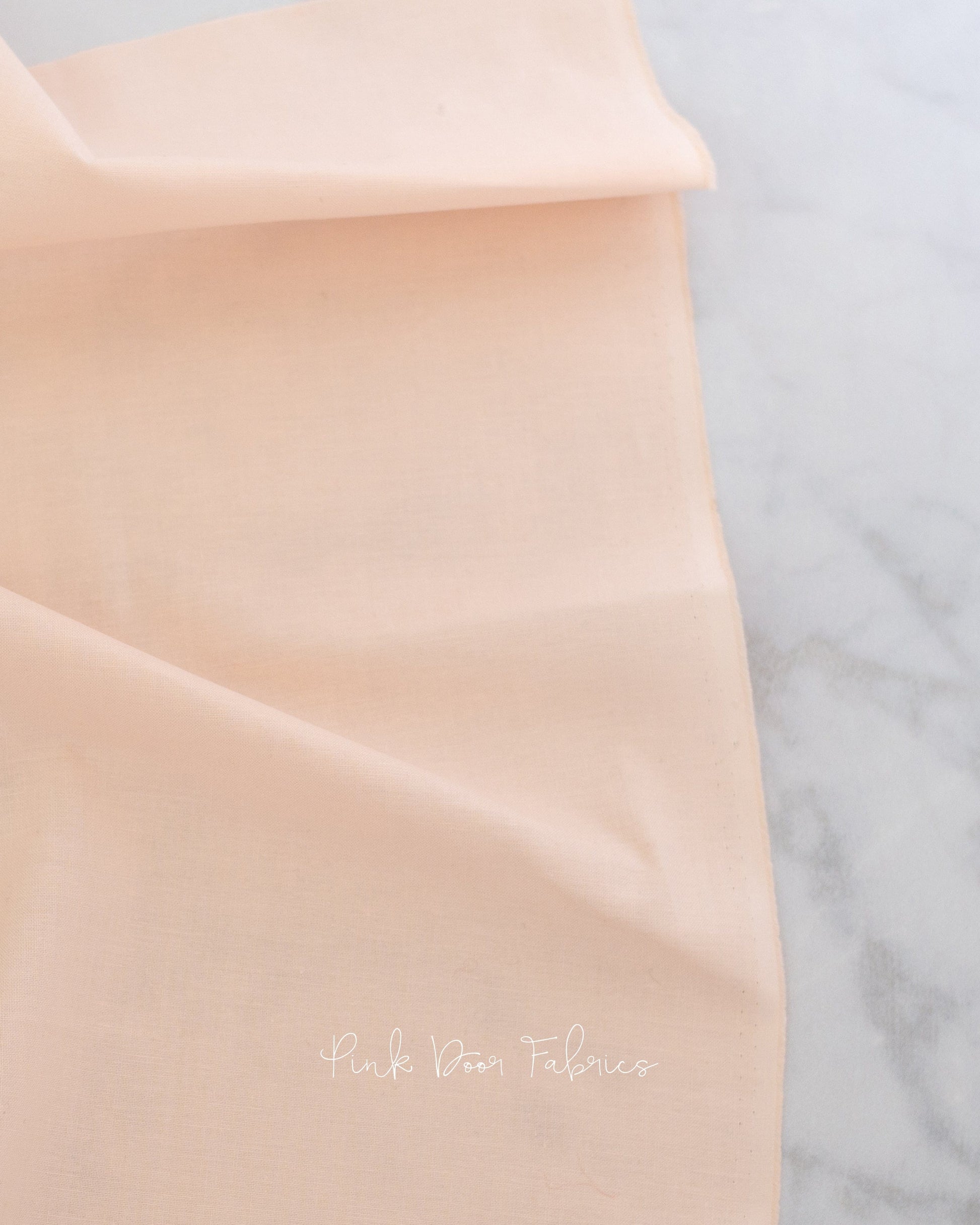 Cotton quilting fabric pattern called 'Unicorn Poop in Peachfuzz'. Part of the 'True Colors' fabric collection. Designed by Tula Pink for fabric company Free Spirit Fabrics. SKU: CSFSESS.PEACHFUZZ. 44-45 inch width.