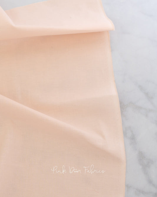 Cotton quilting fabric pattern called 'Unicorn Poop in Peachfuzz'. Part of the 'True Colors' fabric collection. Designed by Tula Pink for fabric company Free Spirit Fabrics. SKU: CSFSESS.PEACHFUZZ. 44-45 inch width.