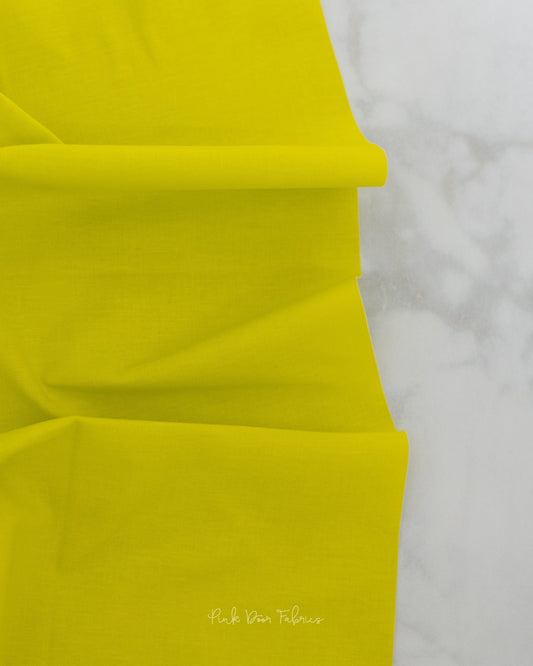 Cotton quilting fabric pattern called 'Solid in Pear'. Part of the 'True Colors' fabric collection. Designed by Tula Pink for fabric company Free Spirit Fabrics. SKU: CSFSESS.PEAR. 44-45 inch width.