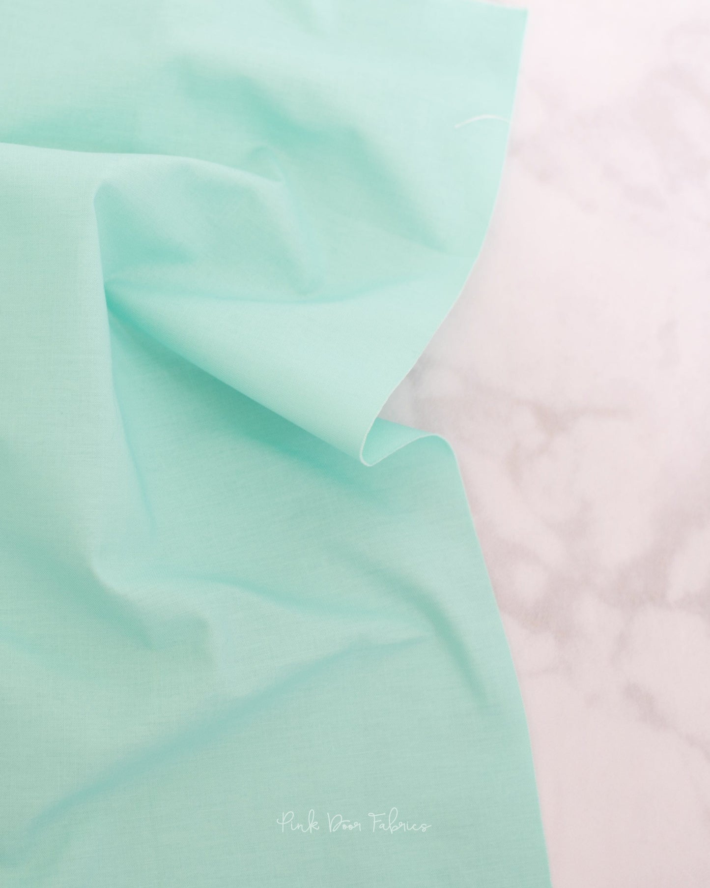 Cotton quilting fabric pattern called 'Solid in Seabreeze'. Part of the 'True Colors' fabric collection. Designed by Tula Pink for fabric company Free Spirit Fabrics. SKU: CSFSESS.SEABREEZE. 44-45 inch width.