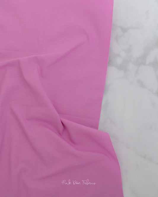 Cotton quilting fabric pattern called 'Solid in Sweet Pea'. Part of the 'True Colors' fabric collection. Designed by Tula Pink for fabric company Free Spirit Fabrics. SKU: CSFSESS.SWEETPEA. 44-45 inch width.