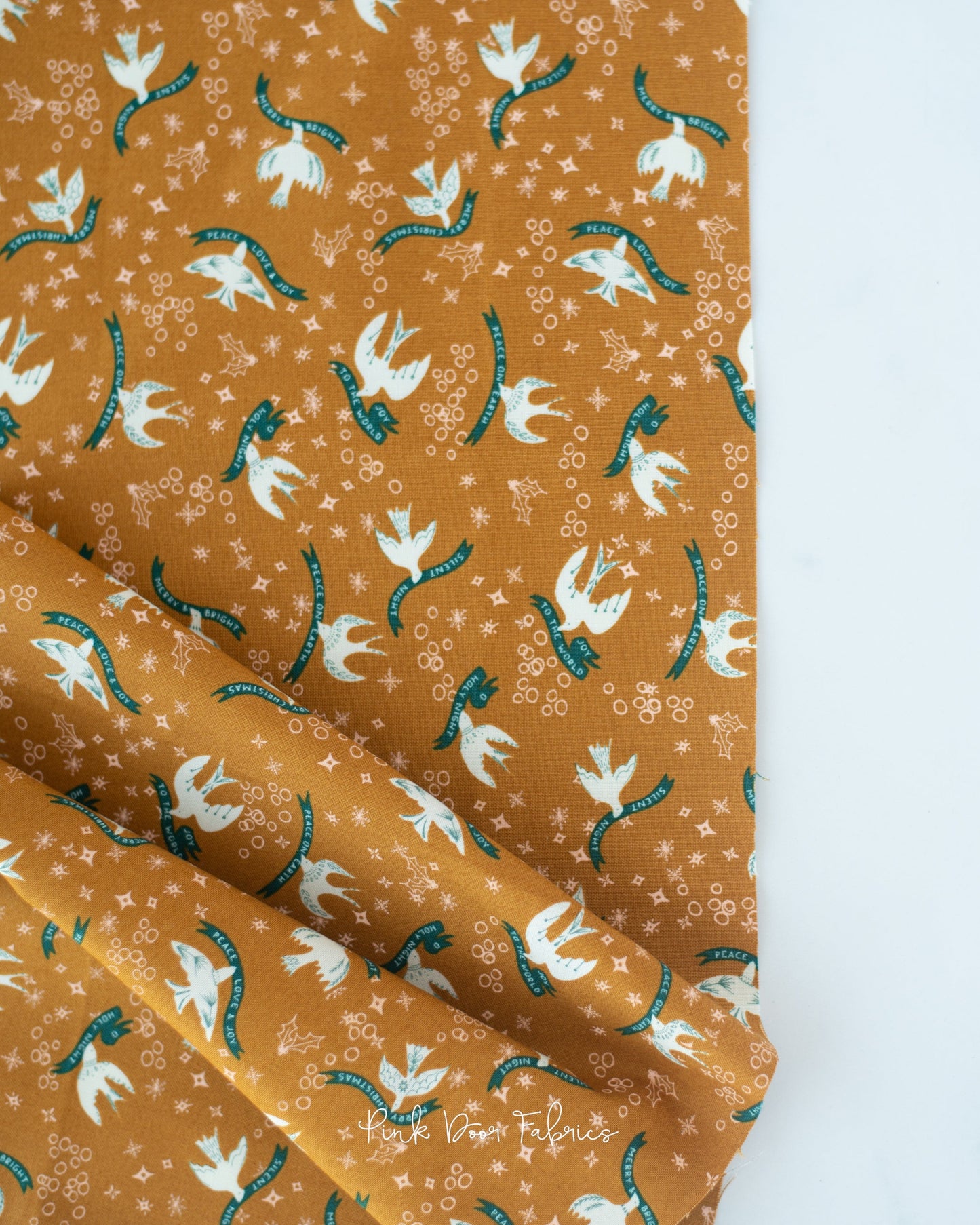 Cotton quilting fabric pattern called 'Good Tidings in Brass'. Part of the 'Cheer & Merriment' fabric collection. Designed by Fancy That Design House for fabric company Moda Fabrics. SKU: 45532 15. 44-45 inch width.