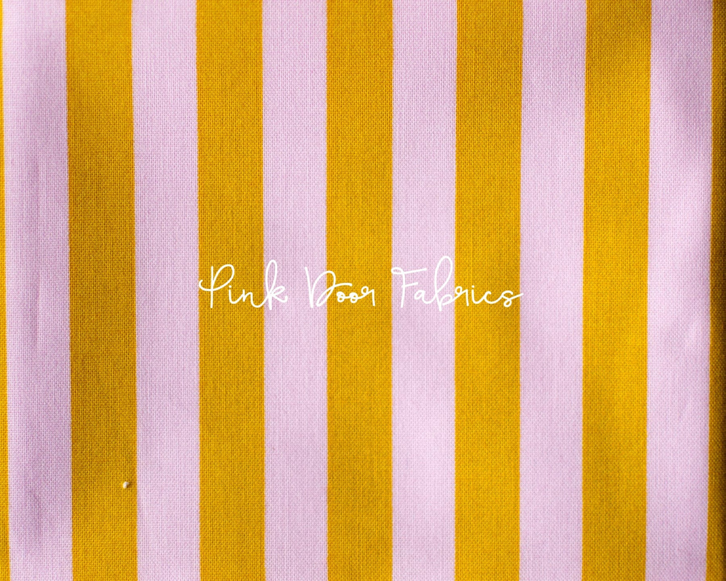 Cotton quilting fabric pattern called 'Tent Stripe in Marigold'. Part of the 'True Colors' fabric collection. Designed by Tula Pink for fabric company Free Spirit Fabrics. SKU: PWTP069.MARIGOLD. 44-45 inch width.