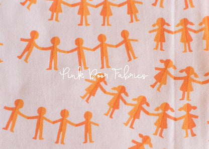 Cotton quilting fabric pattern called 'Paper Dolls in Pink Orange'. Part of the 'Kinder' fabric collection. Designed by Heather Ross for fabric company Windham Fabrics. SKU: 43485-10. 44-45 inch width.